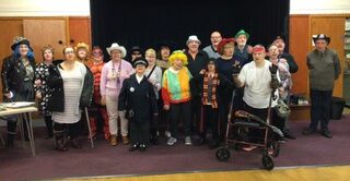 Group of Enable members stand together dressed in Halloween costumes